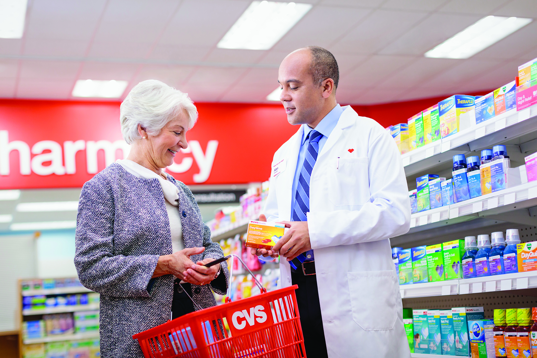 Pharmacist assisting customer in CVS Pharmacy