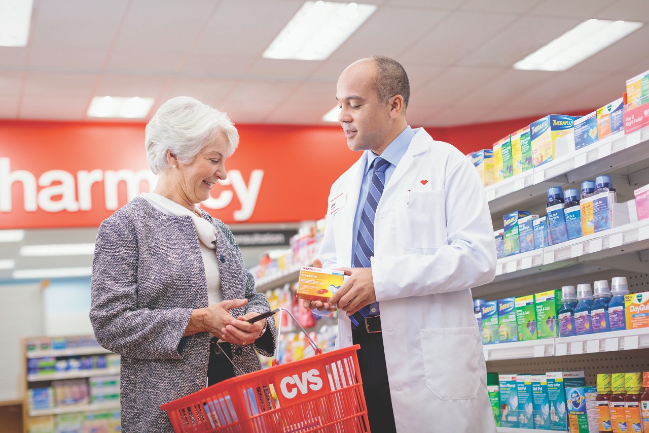 Pharmacist assisting customer in CVS Pharmacy